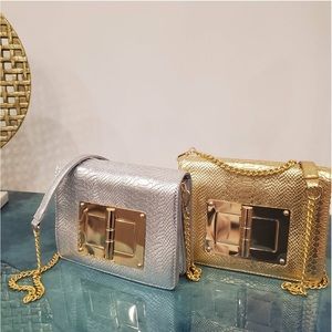Silver and Gold python print shoulder bag w/Gold plate and cross body strap.